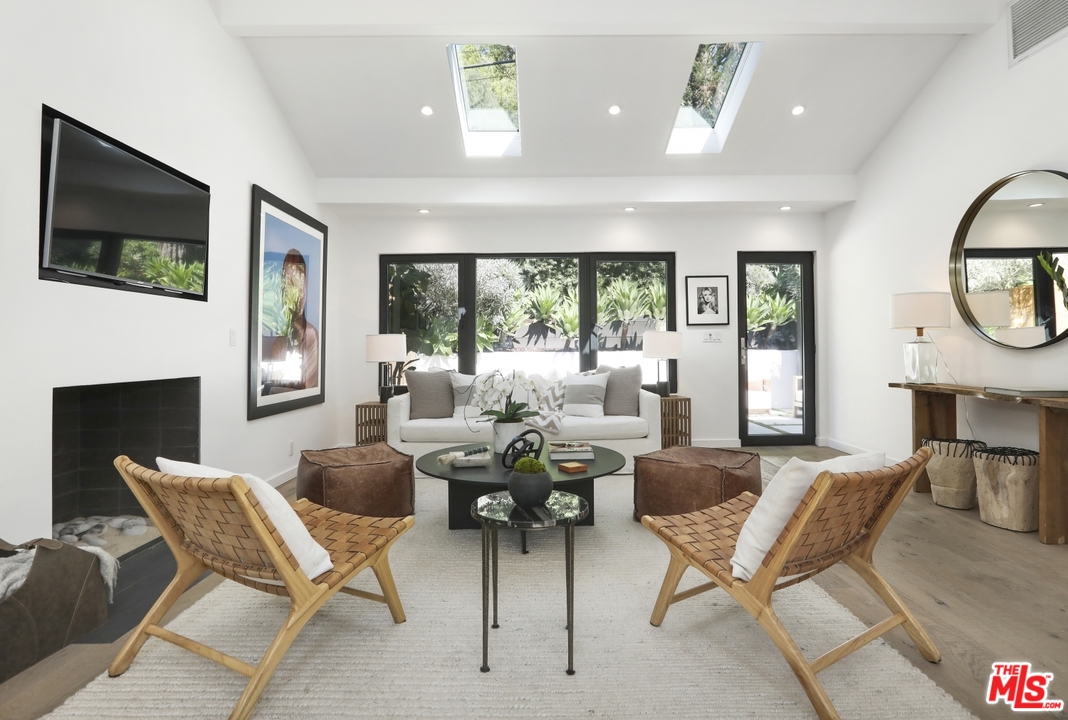 a living room with fireplace furniture and a flat screen tv