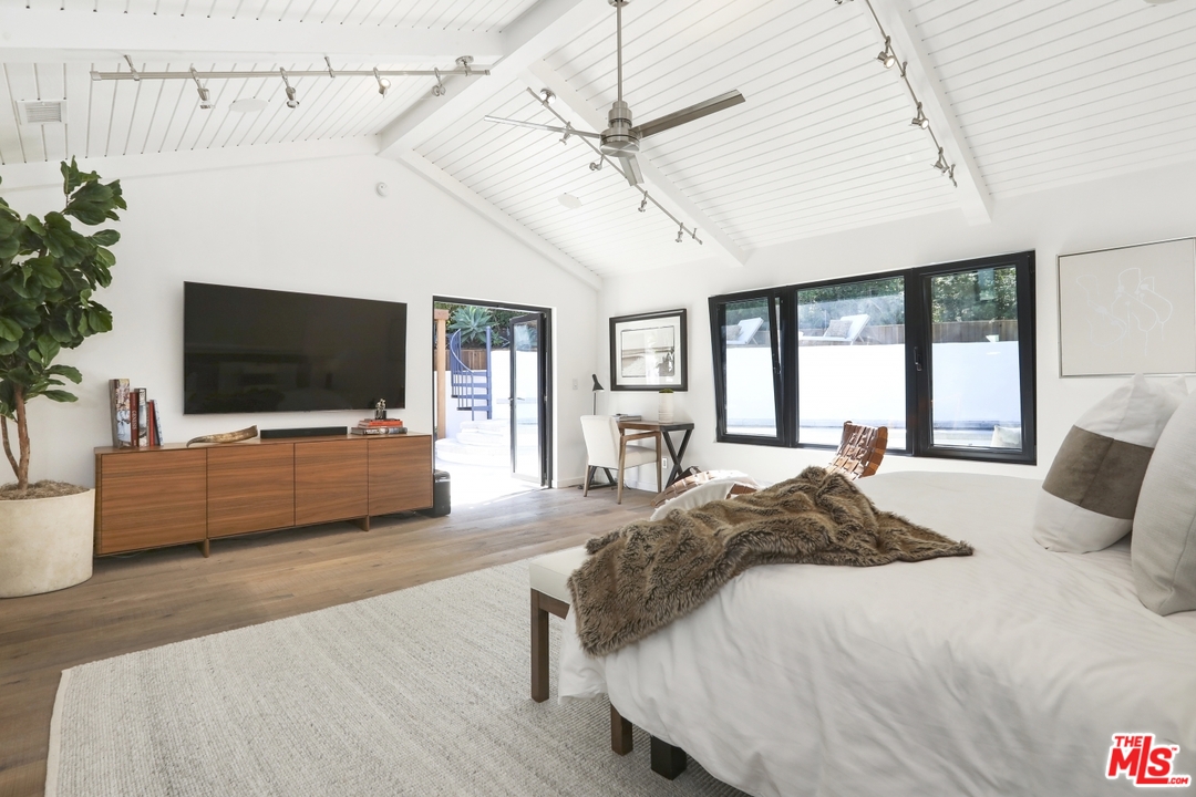 2425 Rinconia Drive Los Angeles, CA 90068 - Photo 13 of 32 a spacious bedroom with a bed and a flat screen tv