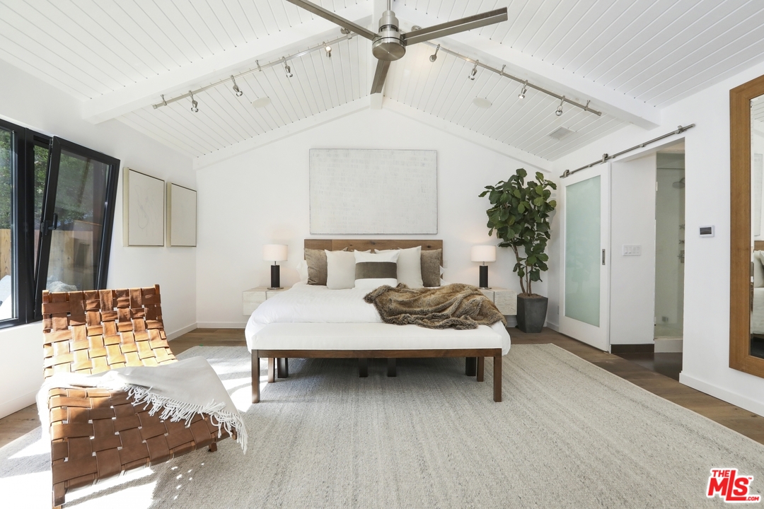 2425 Rinconia Drive Los Angeles, CA 90068 - Photo 14 of 32 a bedroom with a bed lamp and a potted plant