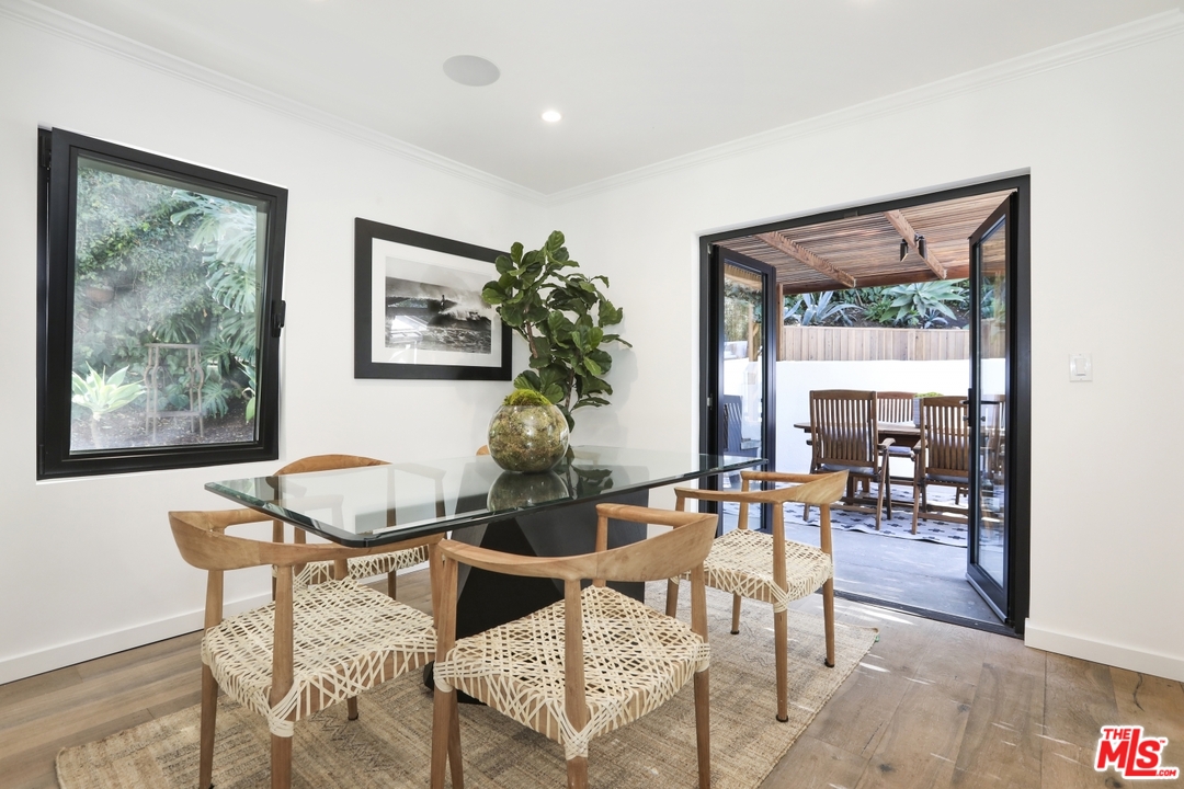 2425 Rinconia Drive Los Angeles, CA 90068 - Photo 19 of 32 a dining room with furniture and a large window