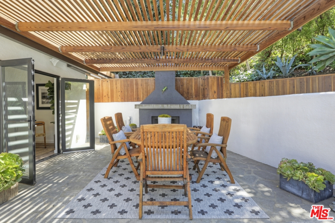 2425 Rinconia Drive Los Angeles, CA 90068 - Photo 20 of 32 a patio with table and chairs