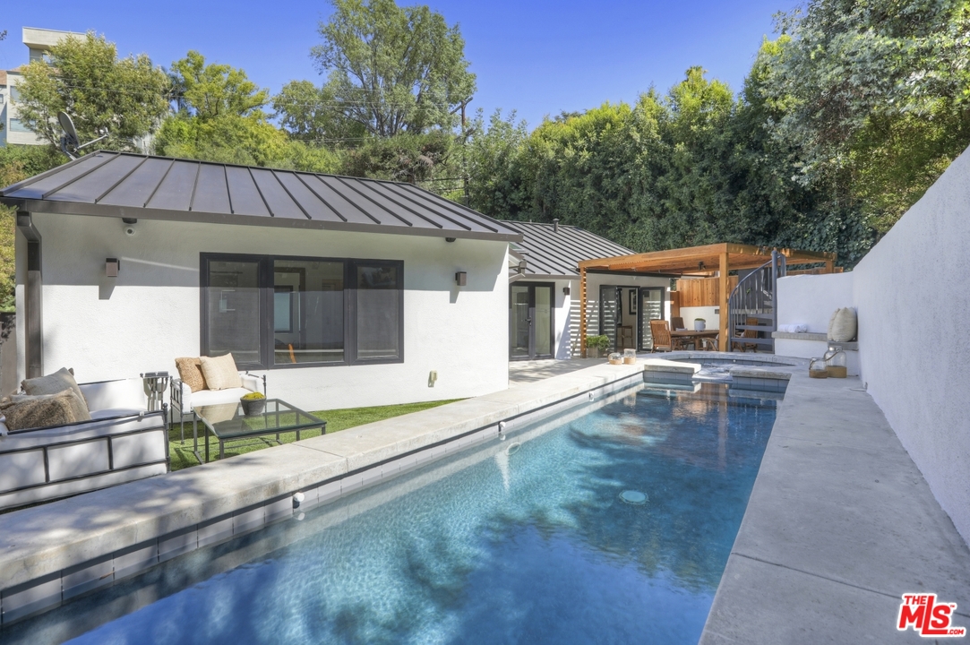 2425 Rinconia Drive Los Angeles, CA 90068 - Photo 23 of 32 a backyard of a house with table and chairs
