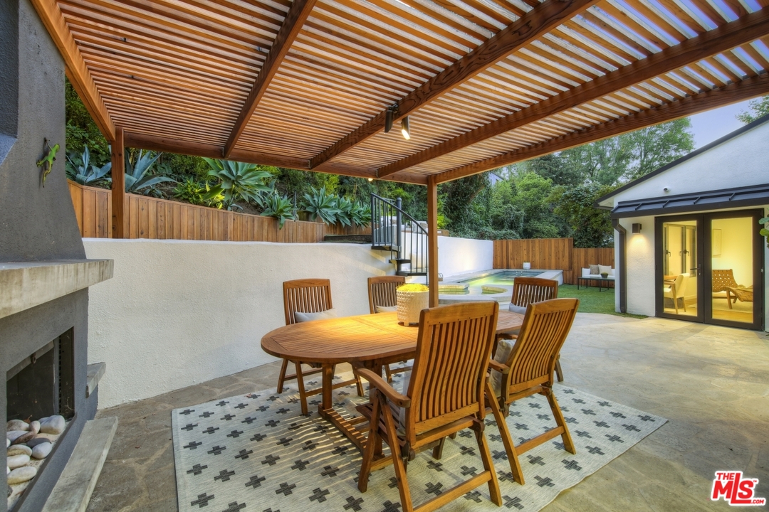 2425 Rinconia Drive Los Angeles, CA 90068 - Photo 29 of 32 a view of a backyard with table and chairs