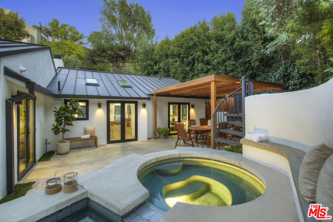 2425 Rinconia Drive Los Angeles, CA 90068 - Photo 31 of 32 a view of a house with swimming pool and sitting area