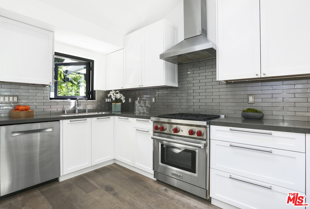 2425 Rinconia Drive Los Angeles, CA 90068 - Photo 10 of 32 a kitchen with granite countertop a stove sink and cabinets