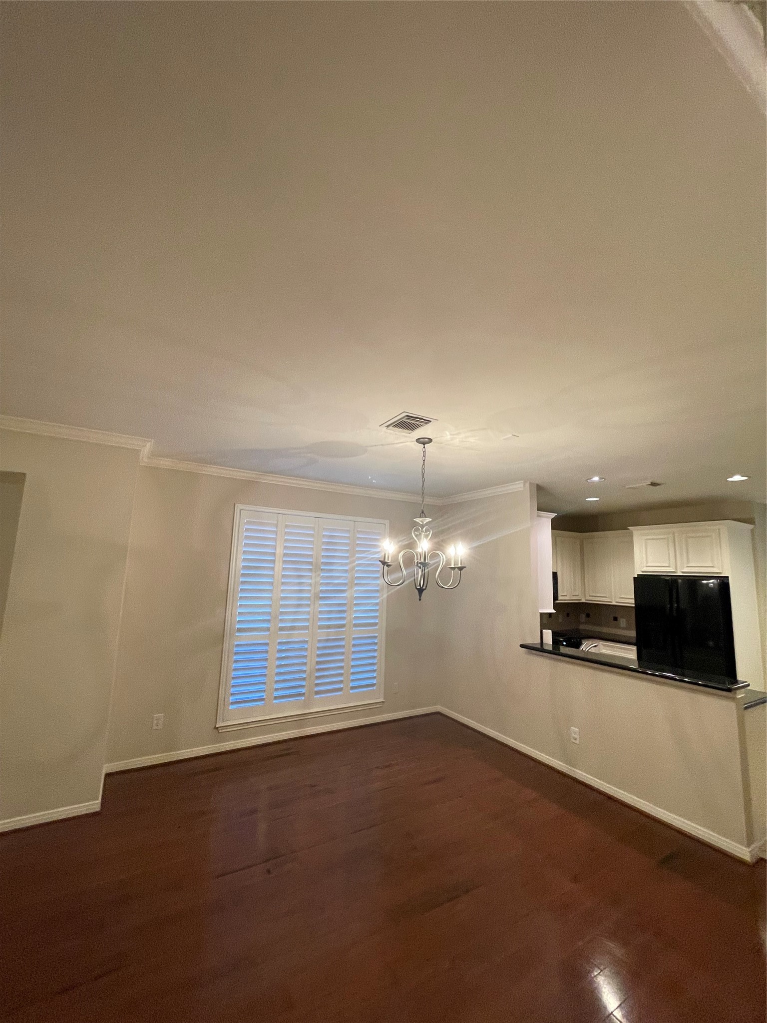 1040 La Rue Street Houston, TX 77019 - Photo 17 of 29 an empty room with kitchen view and wooden floor