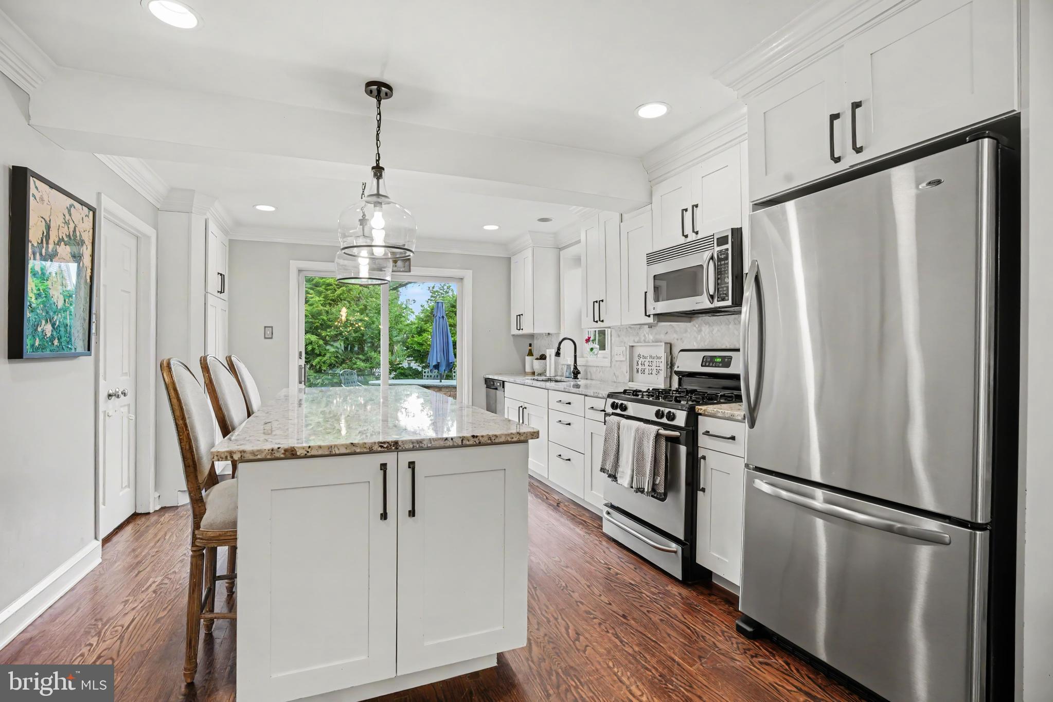 235 Hopkins Road Haddonfield, NJ 08033 - Photo 7 of 47 a kitchen with stainless steel appliances granite countertop a refrigerator a stove a sink dishwasher a oven with white cabinets and wooden floor