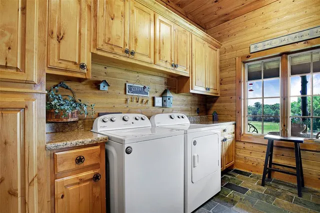 a view of washer and dryer with kitchen area