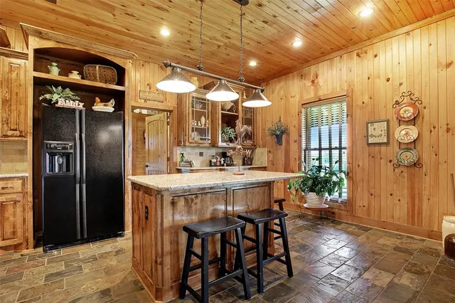 a kitchen with stainless steel appliances a refrigerator and a table