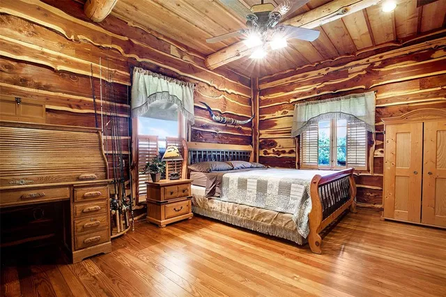 a bedroom with a bed and wooden floor