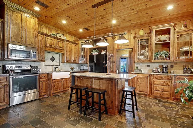 a kitchen with stainless steel appliances a stove a sink dishwasher and a refrigerator