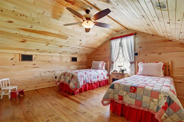 a bedroom with two beds and a chandelier