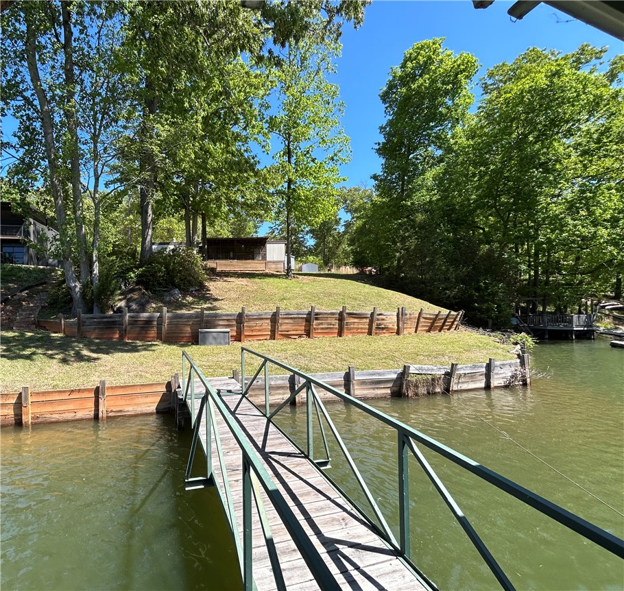 43 Sunset Cove Road Abbeville, SC 29620 - Photo 35 of 41 This serene waterfront property offers direct lake access and lush, tree-lined surroundings.