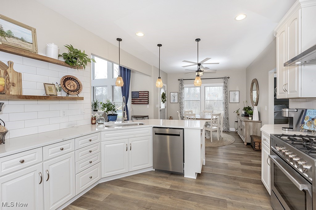 11651 Colburn Road Painesville, OH 44077 - Photo 12 of 42 Kitchen with SS appliances, granite countertops and a peninsula