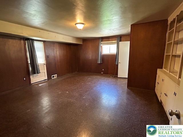 2065 Hopewell Road Bethlehem, PA 18017 - Photo 14 of 19 A spacious room offers built-in shelving, windows, and an exterior door for flexible use.