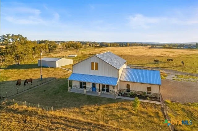 an aerial view of a house with a yard