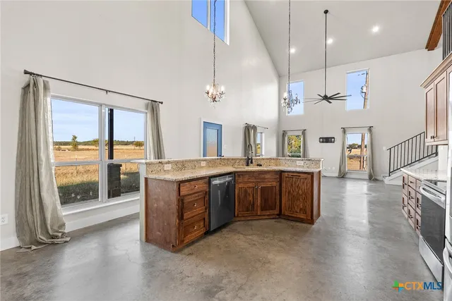 a large kitchen with a large window and stainless steel appliances