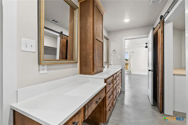 a spacious bathroom with a double vanity sink mirror and double