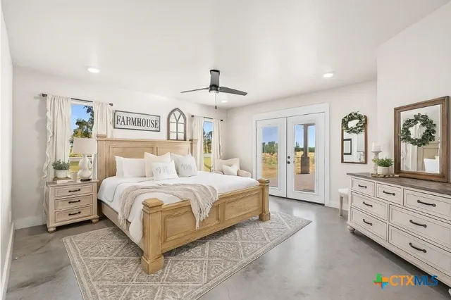 a spacious bedroom with a large bed and a dresser