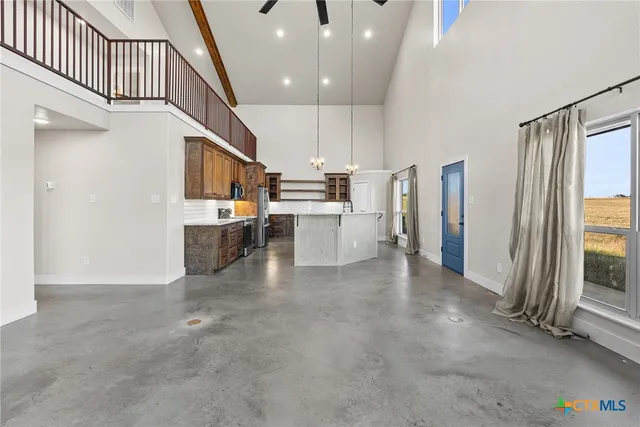 a view of a kitchen with furniture and staircase