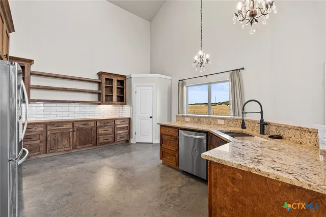 a spacious en suite bathroom with a double vanity sink a mirror and bathtub