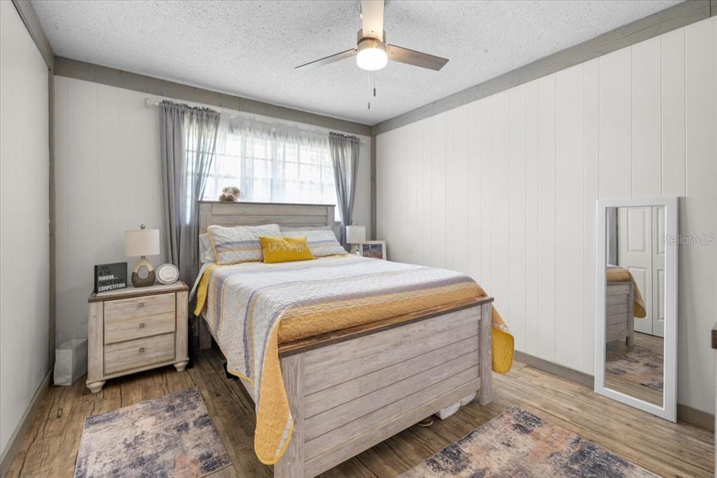 7422 County Road 231 Lake Butler, FL 32054 - Photo 32 of 57 a bedroom with a bed and a chandelier