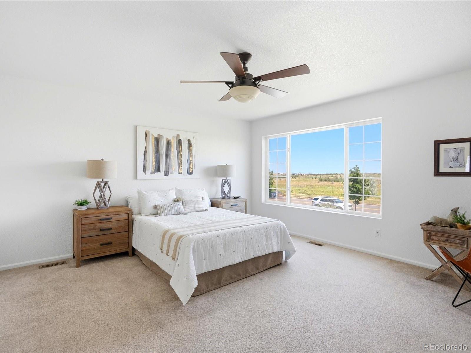 5444 Perth Court Denver, CO 80249 - Photo 24 of 46 a bedroom with a bed and a window