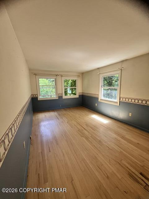 101 Knob Road Mount Pocono, PA 18344 - Photo 14 of 18 a view of an empty room with a window and wooden floor