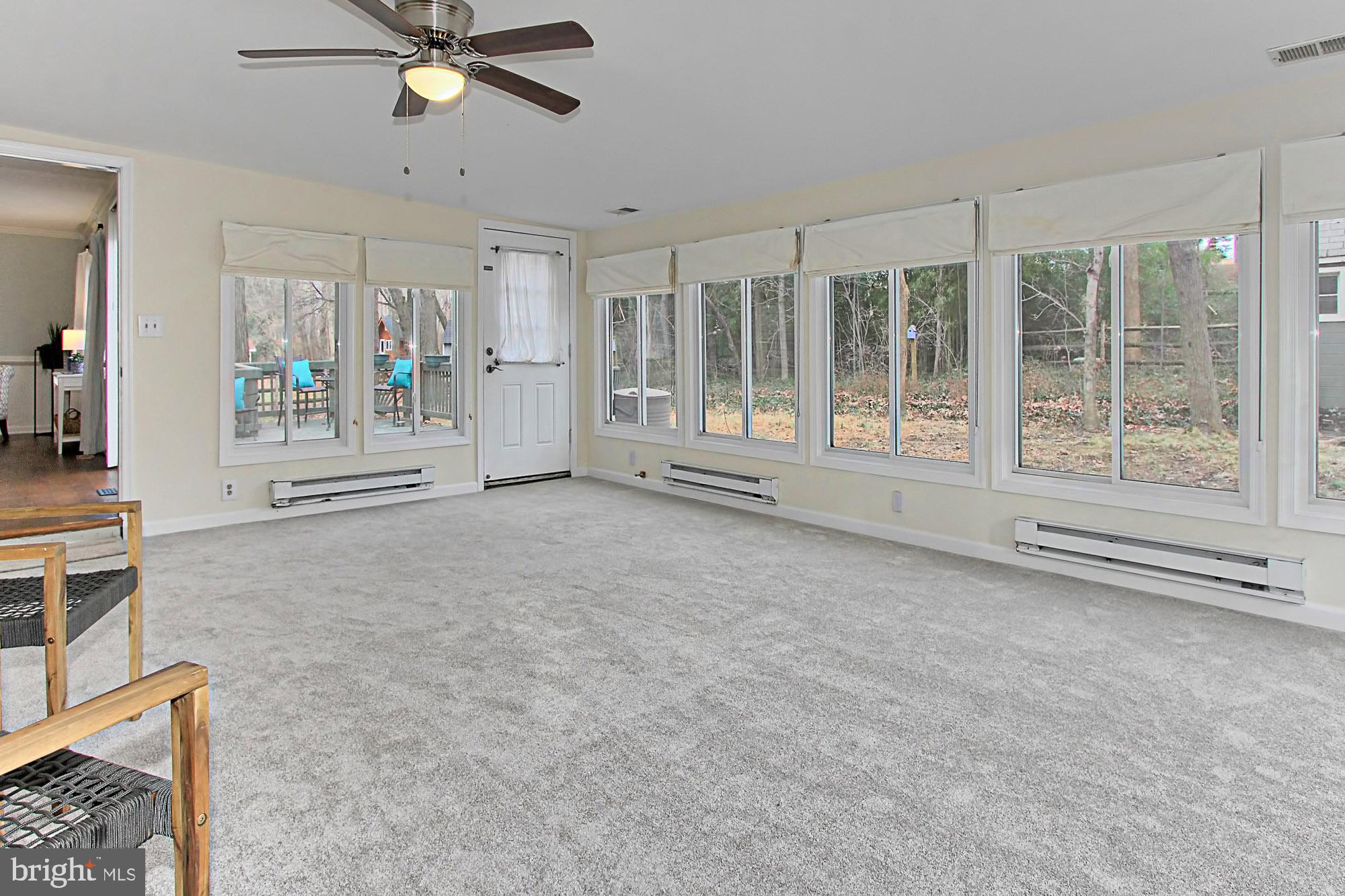 12302 Coleraine Court Reston, VA 20191 - Photo 12 of 35 Sunroom with new carpet opens to the large deck!