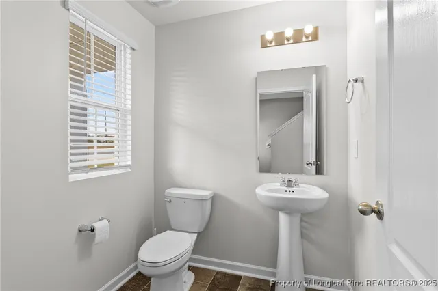 a bathroom with a sink toilet and mirror