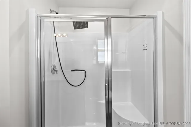 a bathroom with a glass shower door
