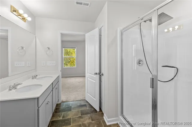 a bathroom with a double vanity sink and a mirror
