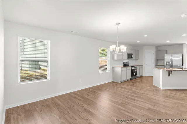 a view of a kitchen with granite countertop cabinets and wooden floor