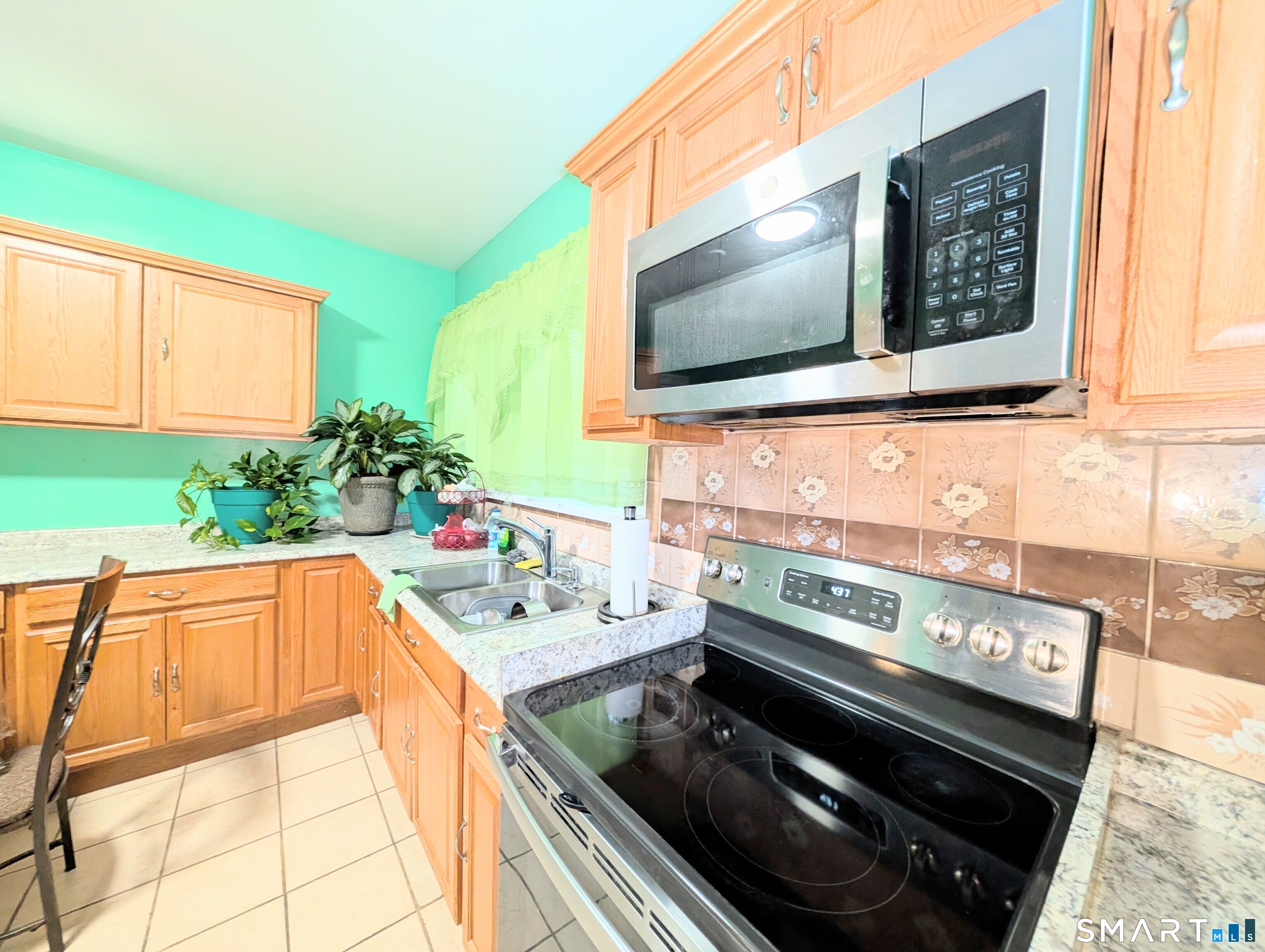454 Pembroke Street Bridgeport, CT 06608 - Photo 11 of 40 a kitchen with a stove and a microwave