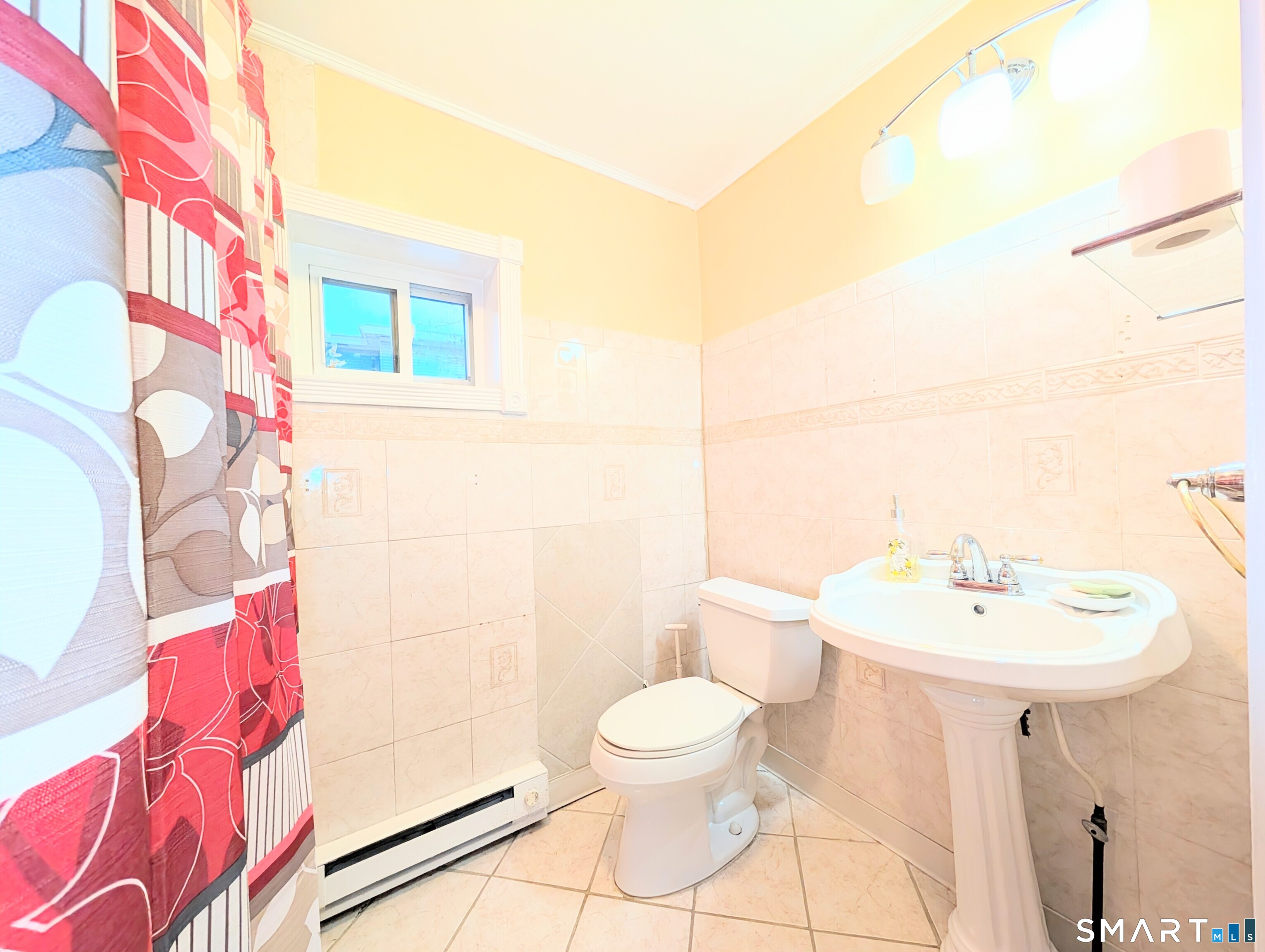 454 Pembroke Street Bridgeport, CT 06608 - Photo 13 of 40 a bathroom with a sink a toilet and shower