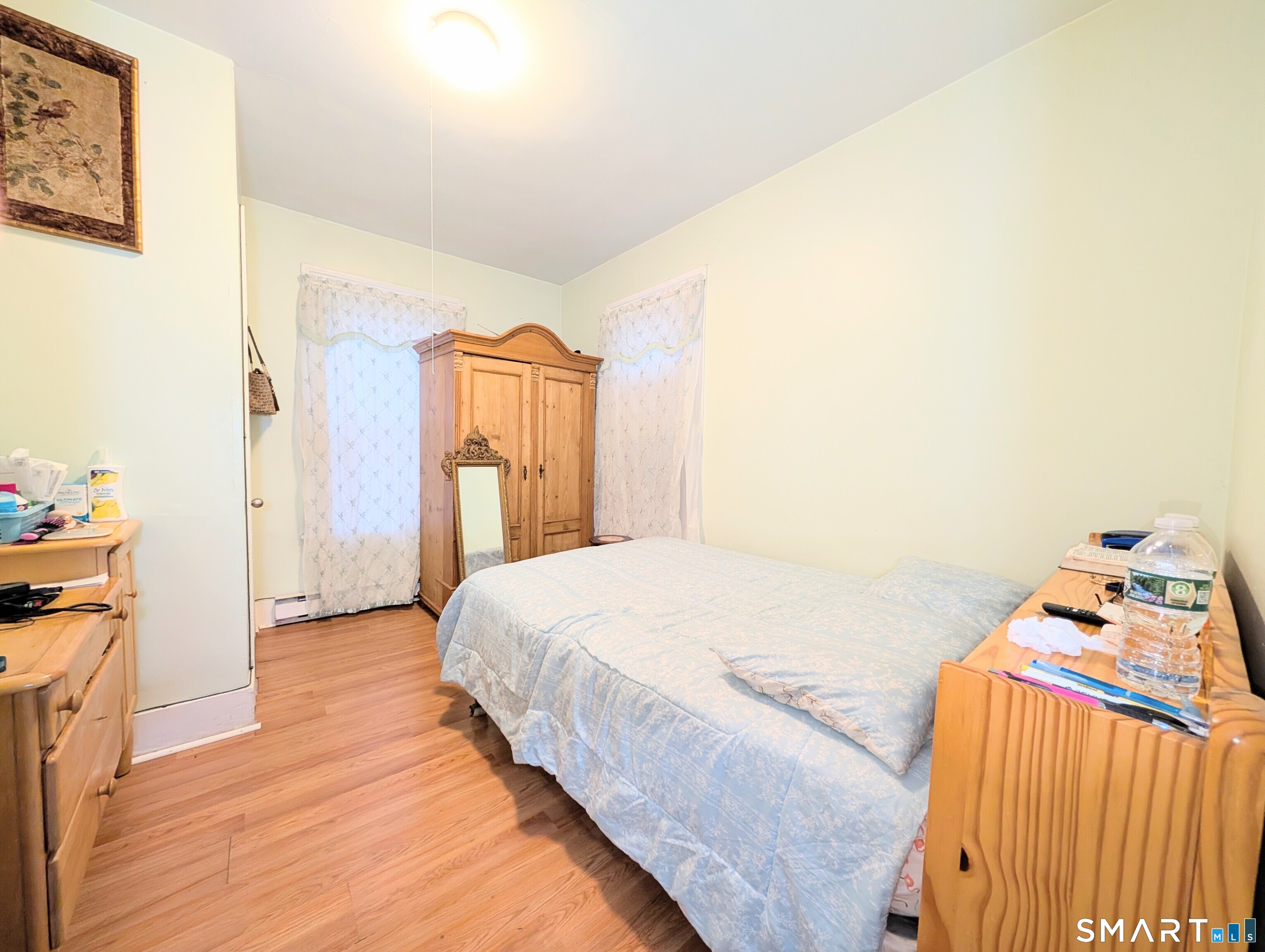 454 Pembroke Street Bridgeport, CT 06608 - Photo 15 of 40 a bedroom with a bed and a mirror on the dresser