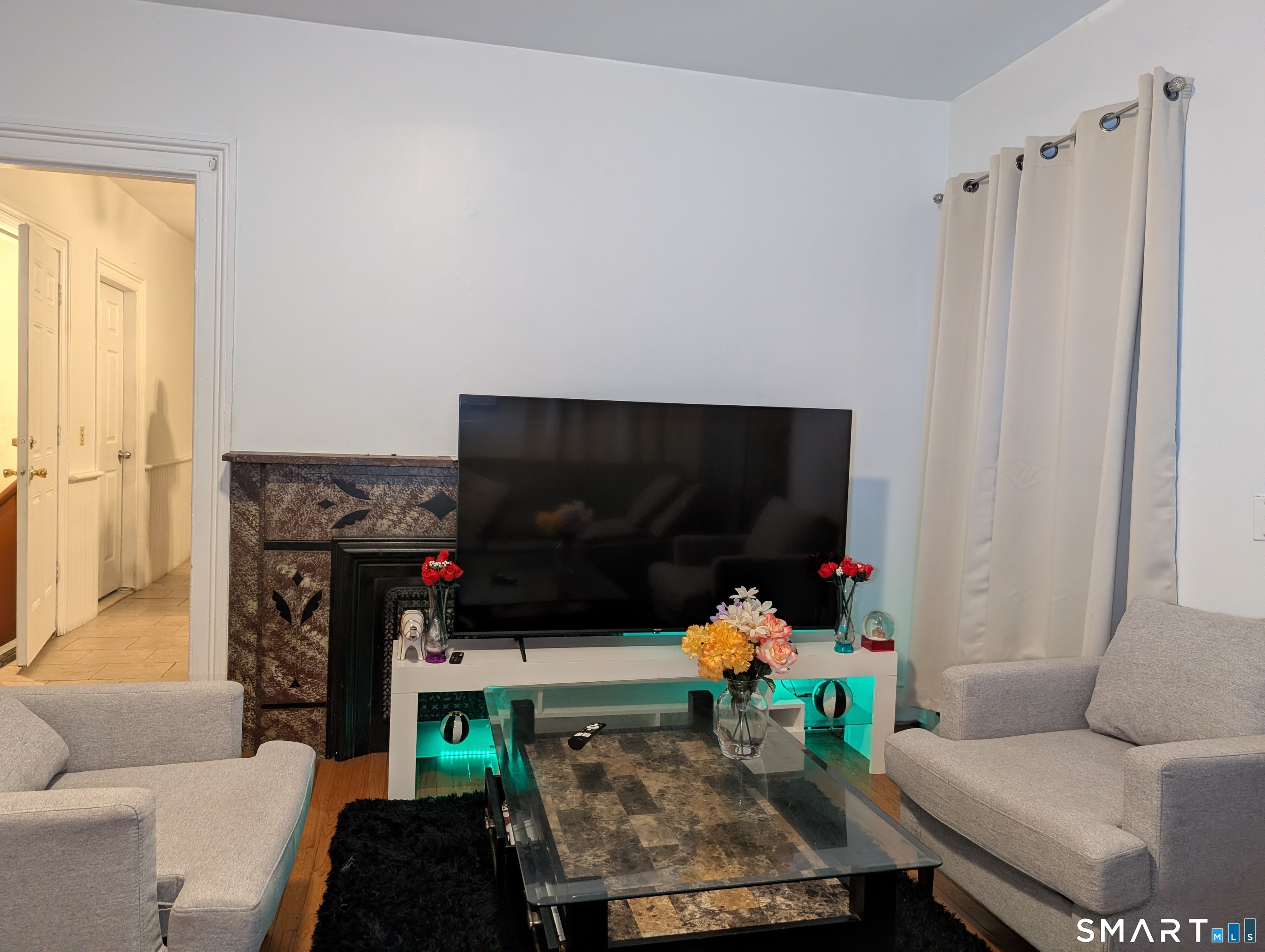 454 Pembroke Street Bridgeport, CT 06608 - Photo 19 of 40 a living room with furniture and a flat screen tv