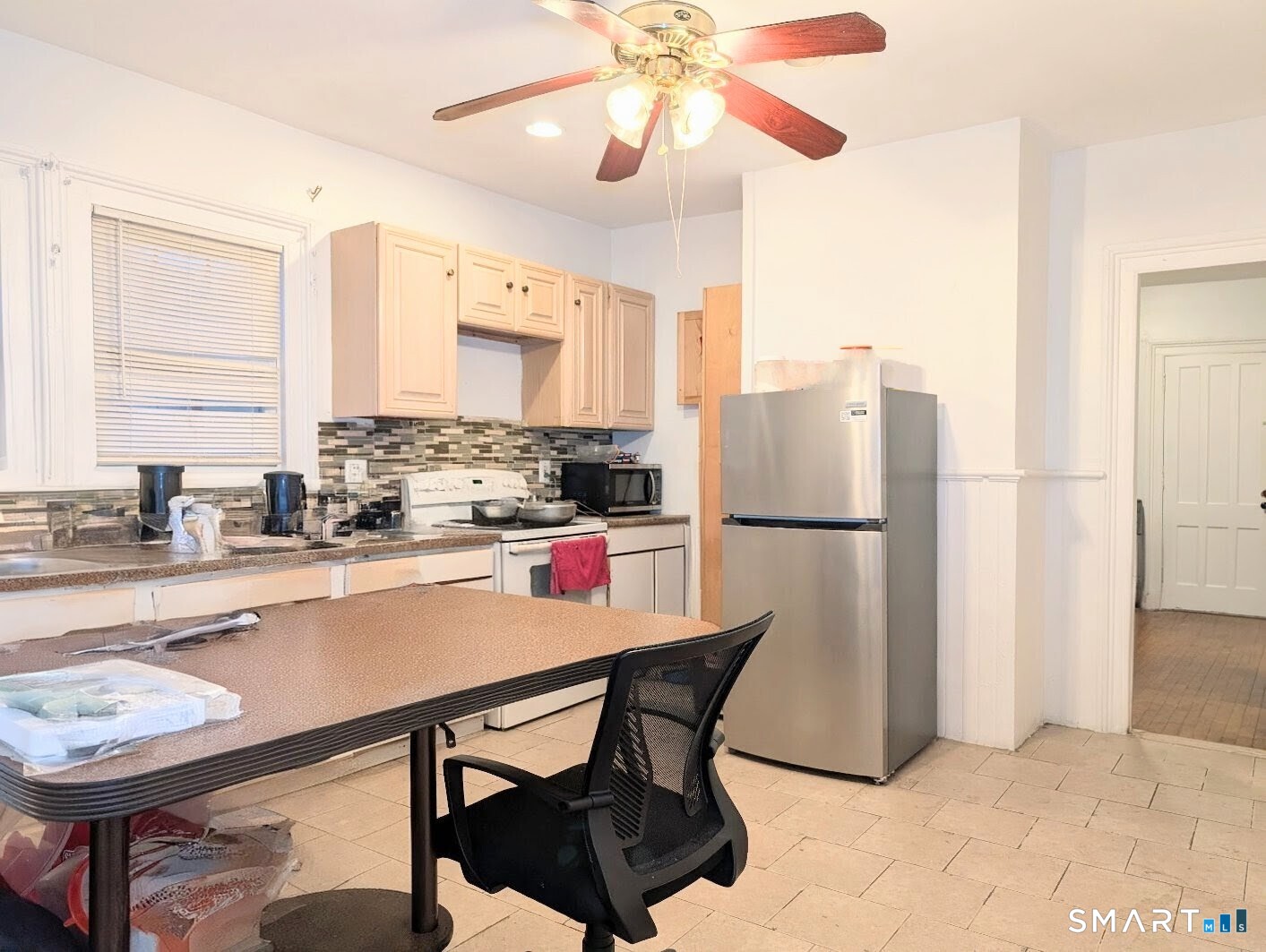 454 Pembroke Street Bridgeport, CT 06608 - Photo 20 of 40 a kitchen with refrigerator and window