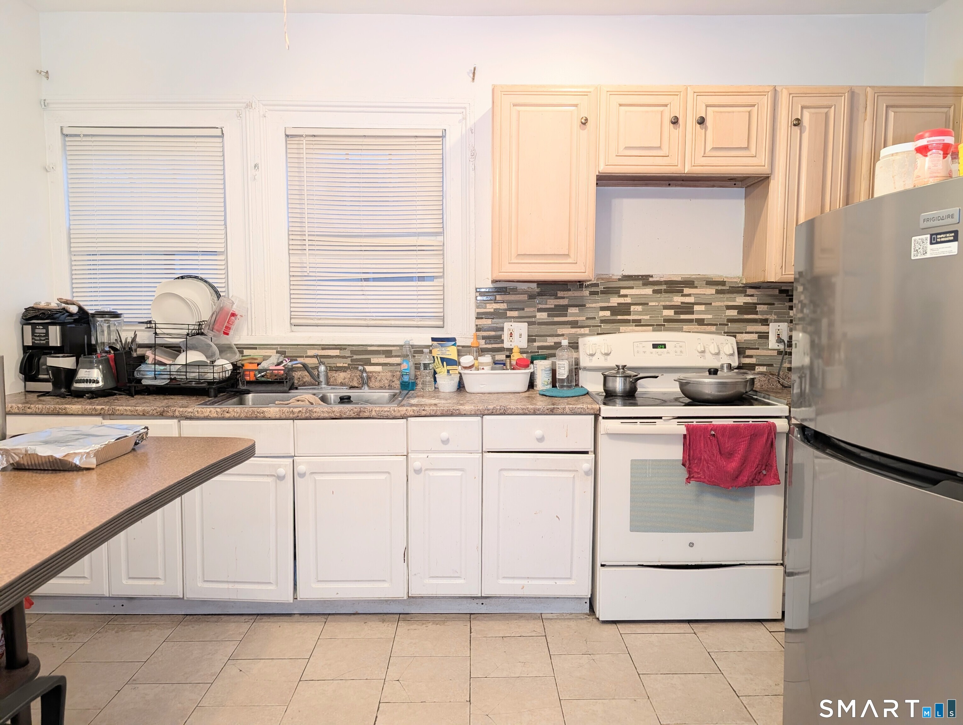 454 Pembroke Street Bridgeport, CT 06608 - Photo 21 of 40 a kitchen with cabinets appliances and a sink