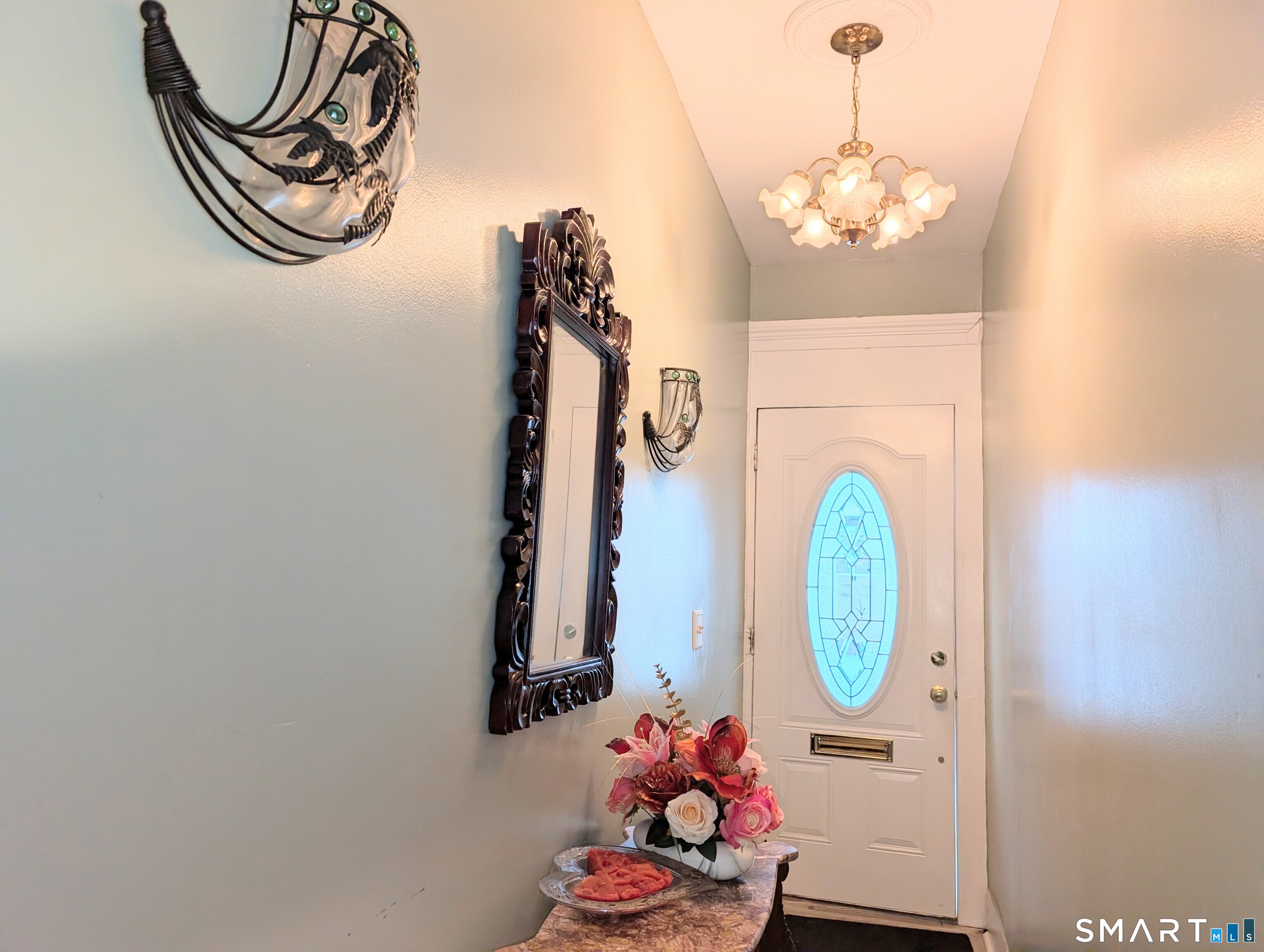 454 Pembroke Street Bridgeport, CT 06608 - Photo 5 of 40 a view of a entryway with furniture and chandelier