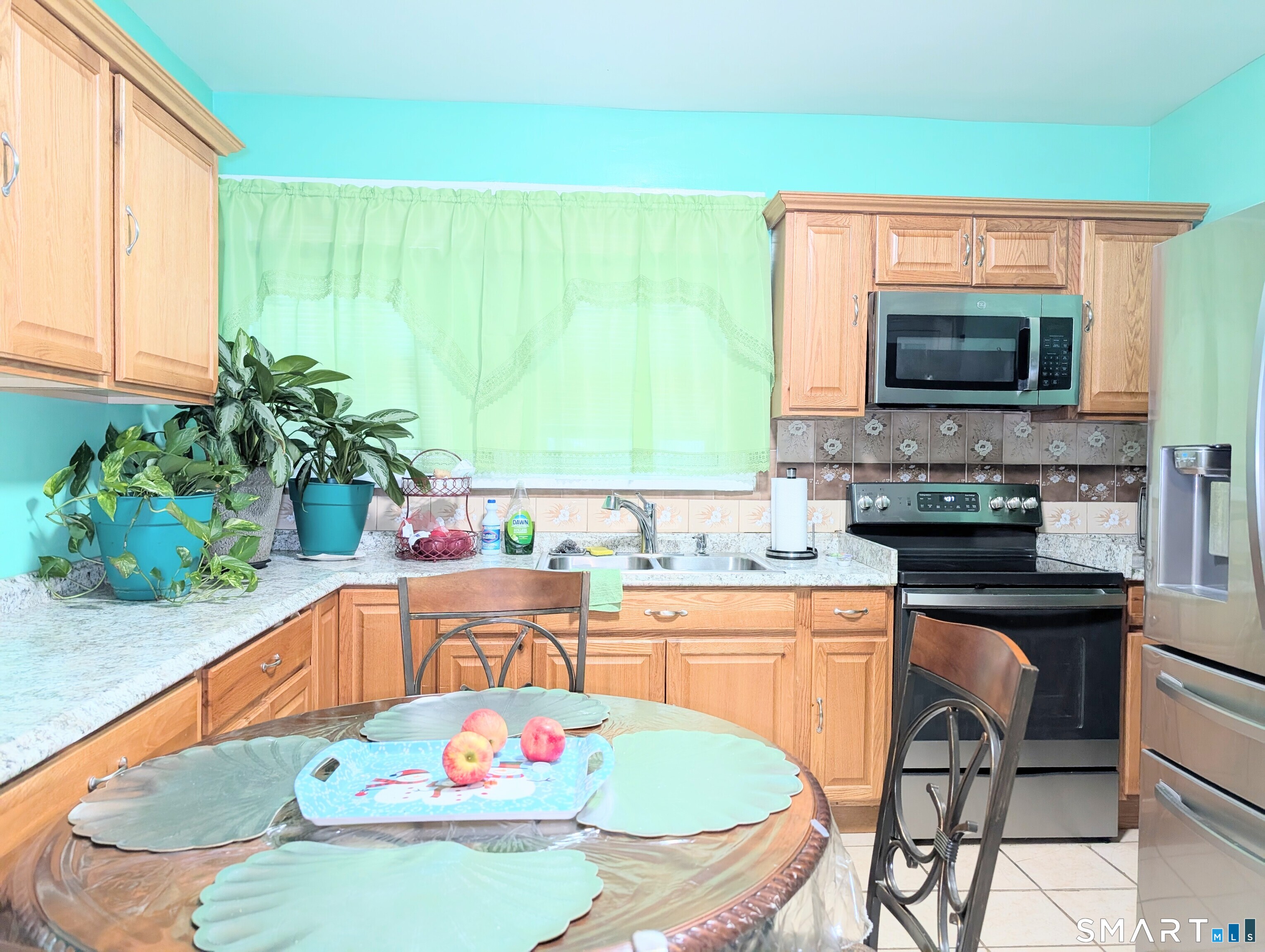 454 Pembroke Street Bridgeport, CT 06608 - Photo 9 of 40 a kitchen with a stove a sink and a microwave