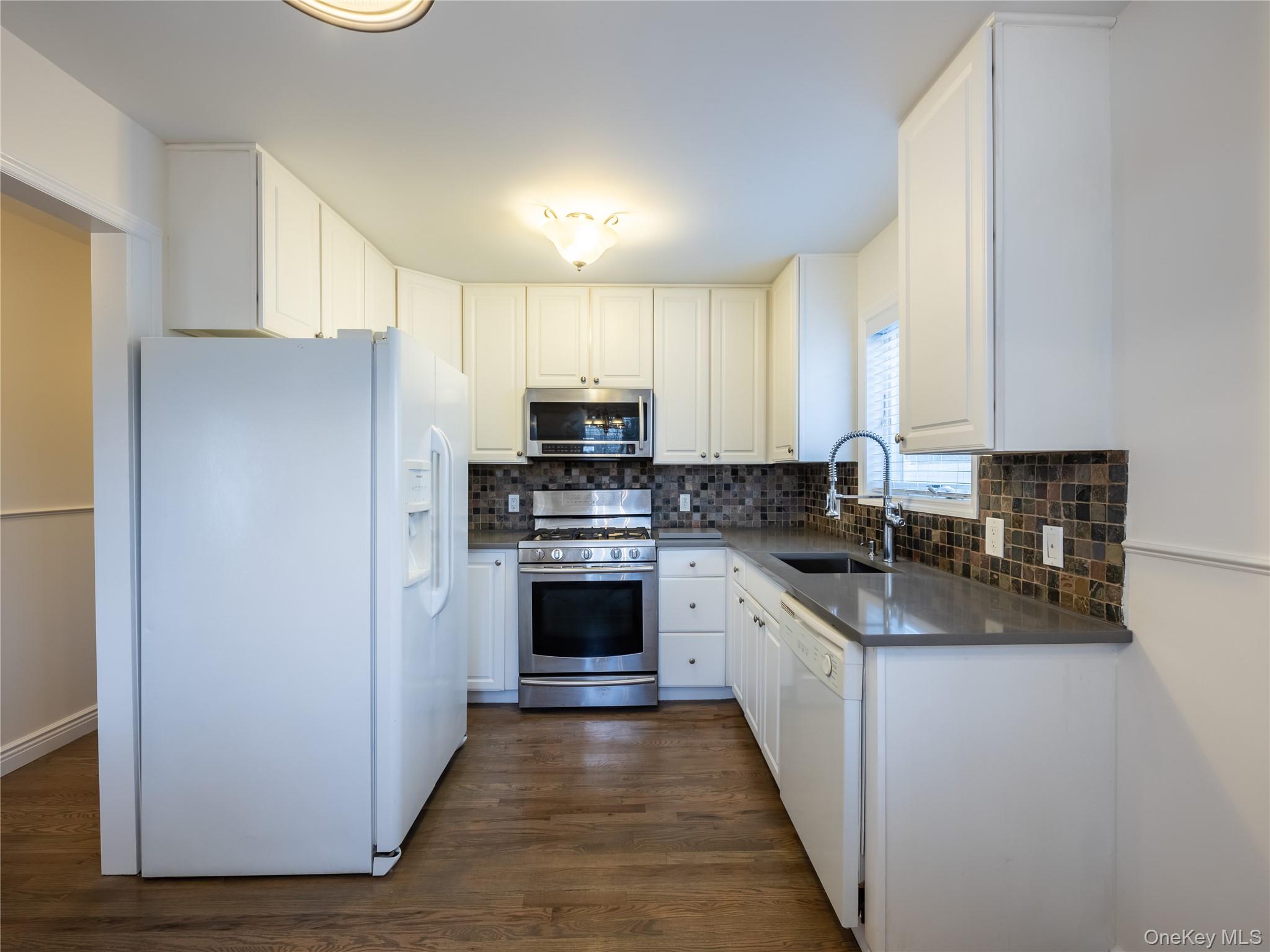 21 Marwood Road North Port Washington, NY 11050 - Photo 28 of 35 a kitchen with stainless steel appliances a refrigerator sink and stove