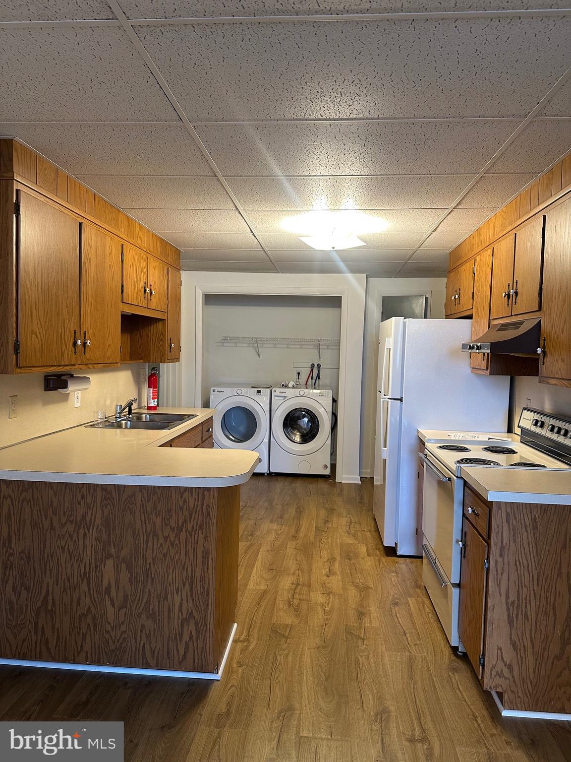 2 Dry Wells Road, Unit C Christiana, PA 17509 - Photo 2 of 6 a kitchen with stainless steel appliances granite countertop a stove a sink dishwasher and a refrigerator with wooden floor