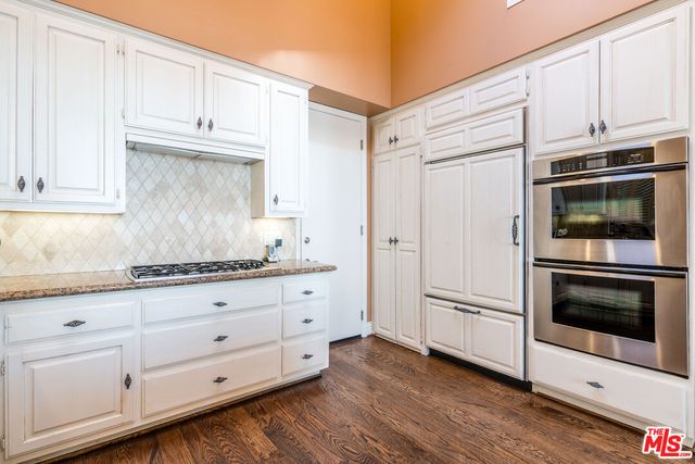 a living room with furniture wooden floor and a table