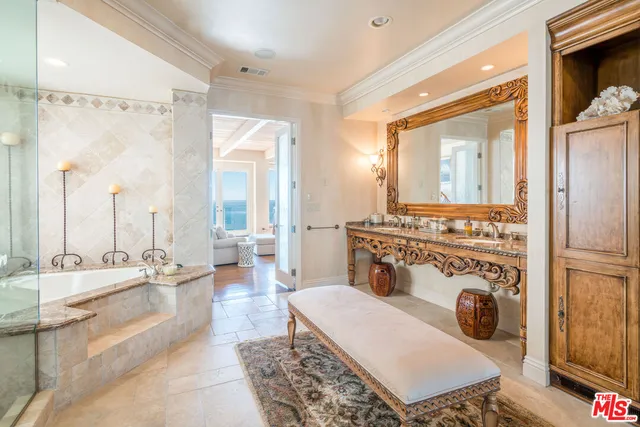 a bathroom with a tub sink and shower