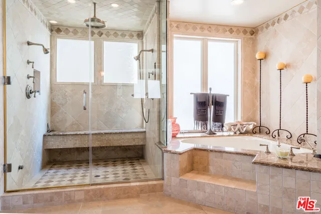 a balcony with wooden floor and outdoor seating