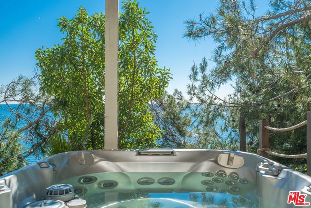 a view of a lake with a table and chairs