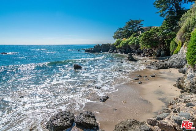 an aerial view of residential house with outdoor space and parking
