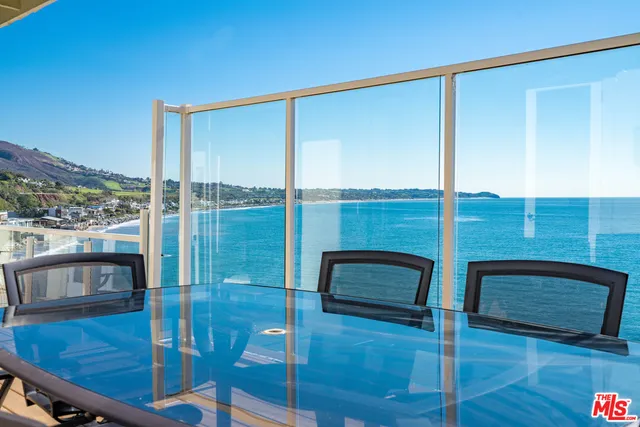 a view of a terrace with wooden floor and lake view