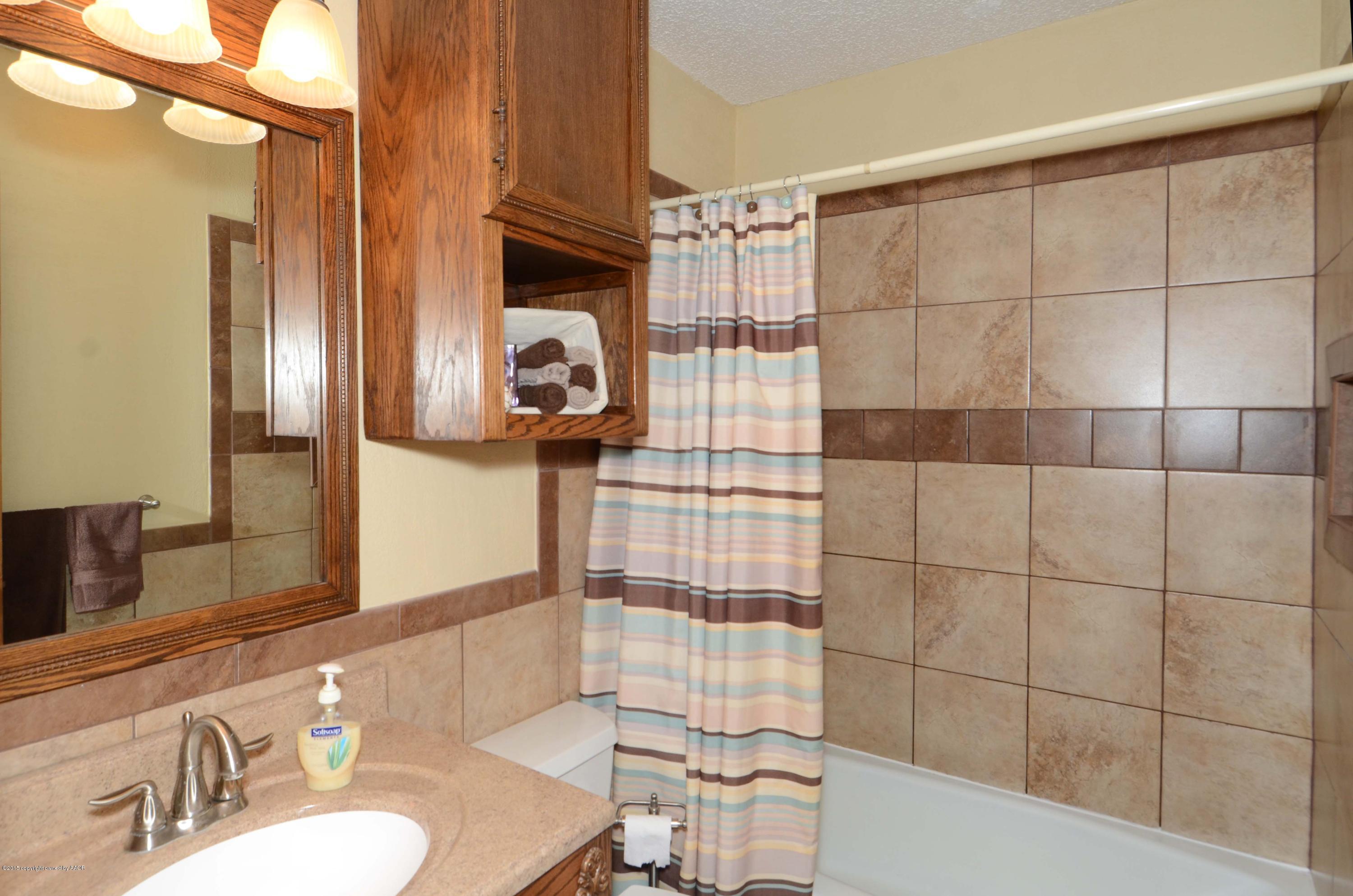 8104 Leah Trail Amarillo, TX 79110 - Photo 11 of 22 a bathroom with a sink toilet and shower